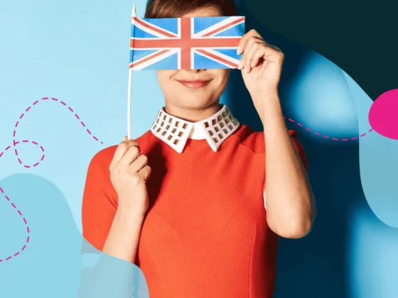 A woman holding a UK flag over her face.