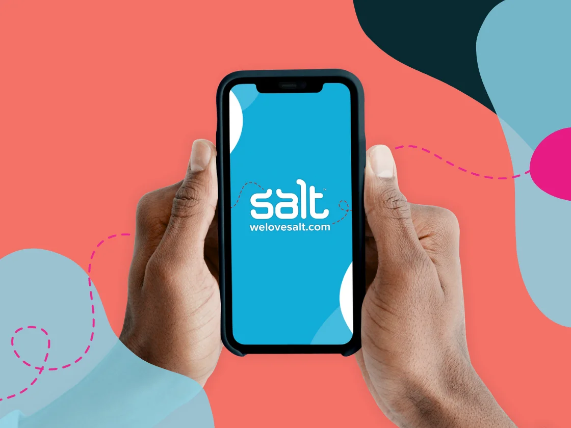 A smartphone being held in two hands with Salt logo and welovesalt.com visible on the screen