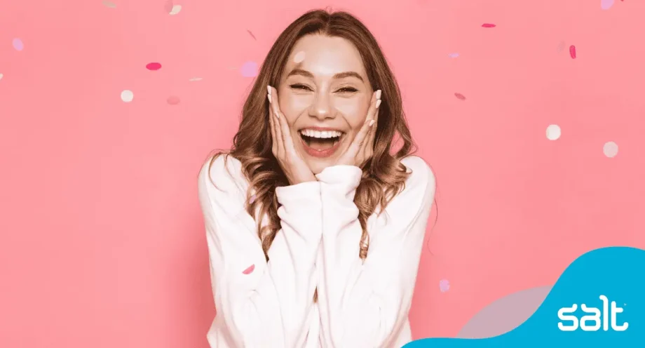 Women celebrating promotion with confetti smiling