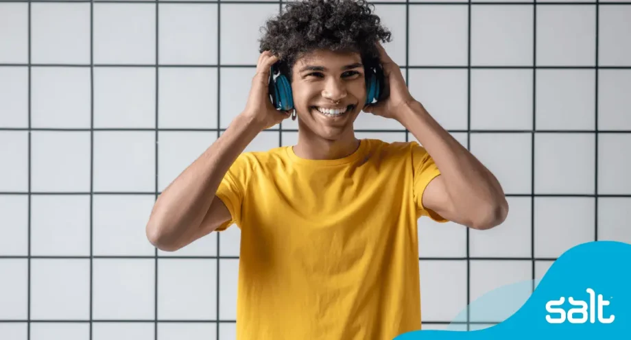 Person wearing headphones against grid background.