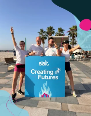 Salt Recruitment team with a sign saying Creating Futures