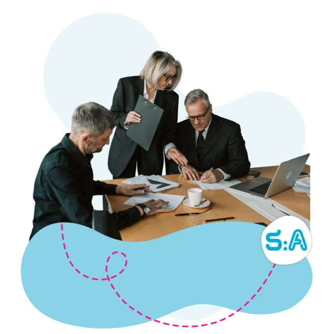 Executive team signing paperwork.